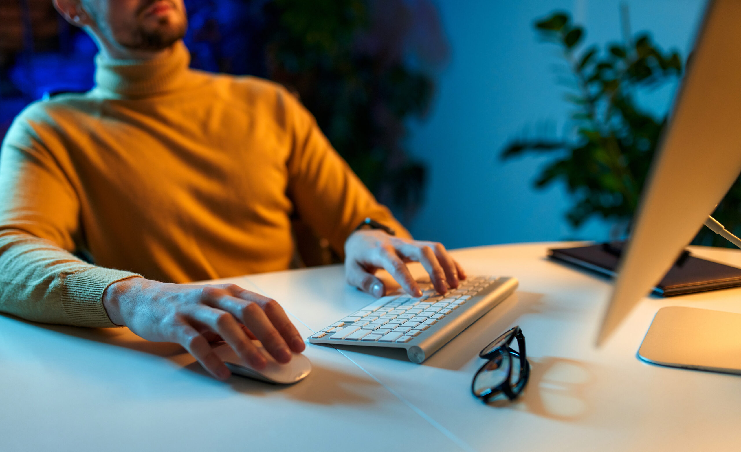 Busineesman hand working on laptop computer, typing keyboard, planning work project in modern office, close up. Executive manager, corporate man proofing business report with digital tablet on desk.